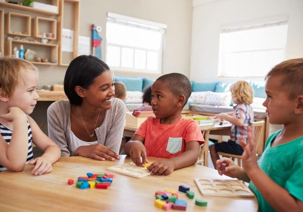 Teacher and children engaging in classroom activities.